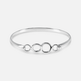 Silver bracelet with interlocking rings on a white background