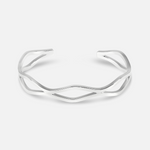 Silver bracelet with a branch-like design on a white background