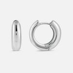 A pair of chunky hoop earrings made of silver metal, displayed against a white background.