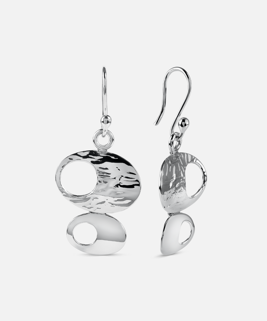 A pair of silver drop earrings with organic, abstract oval and teardrop shapes, featuring textured and polished finishes, shown against a light gray background.