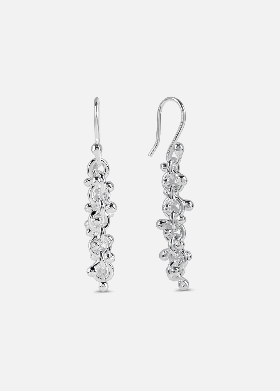 A pair of silver cluster ball dangly earrings on a white background.
