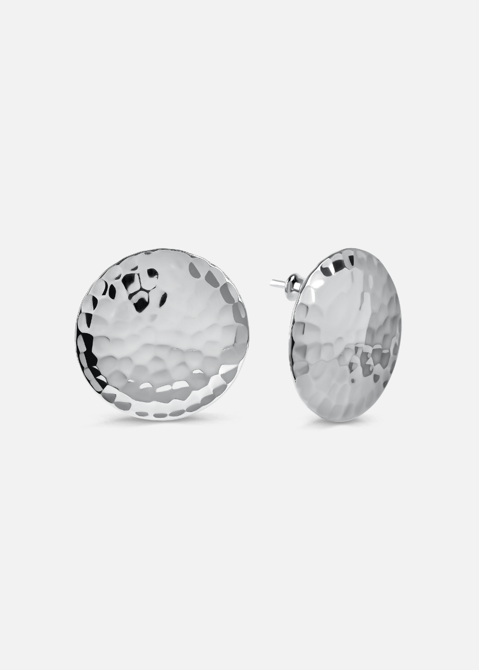 Pair of silver round earrings on a light gray background