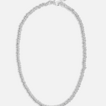 Silver necklace on a light gray background