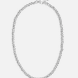 Silver necklace on a light gray background
