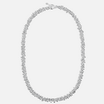 Silver necklace on a light gray background