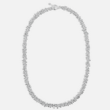 Silver necklace on a light gray background