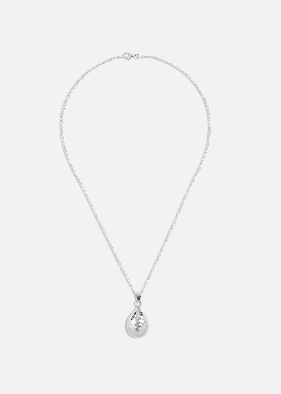 A silver hammered teardrop pendant necklace on a plain background.